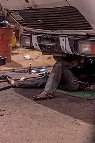 Mechanic lying on a mat.