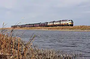 Train running next to a river