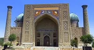 Front facade of the madrasa  in the foreground