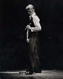 David Bowie performing in 1976 and in character as the Thin White Duke