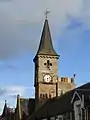 Clock tower, the lower section of which is a remnant of the former town house