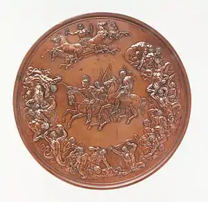 A bronze medal, with allegorical figures surrounding two equestrian figures in the centre