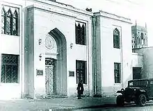 Light-colored, Persian-style, two-story building