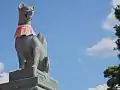 Fox holding a jewel in its mouth at the main gate of the Fushimi Inari shrine