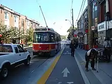 Large transport vehicle leaving sidewalk stop