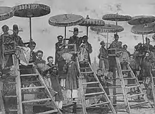 Invigilators seated on high chairs at a provincial exam in 1888 in northern Vietnam