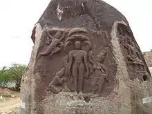 Parshva  or Parsavanathar, 23rd tirthankar. This carving depicts Parsavanathar in meditating position and Dharanendiran, Padmavathy protecting him using umbrella from kamadan who was his past life enemy from throwing rocks to disturb him.