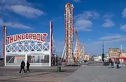 The Thunderbolt roller coaster at West 15th Street, a steel coaster painted orange with white supports