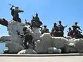 Statue of the Eight Immortals crossing the sea, in Tianjin, China. Lan Caihe is third from the right, holding a flower basket. 2008.