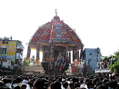 a temple car drawn by a lot of people