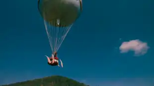 A hot-air balloon ascends to a clear sky