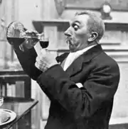 elderly looking man avidly pouring himself a glass of port