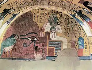 The god Osiris sitting on a throne flanked by Pashedu, who is kneeling in prayer. Behind Pashedu is a Wadjet eye holding a vessel, beyond whom is a falcon.