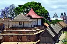 a line of small, low houses with clay roof tiles and gables aligned