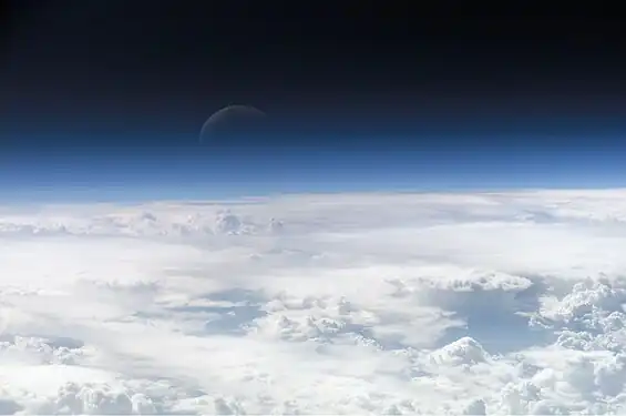 Atmospheric gases scatter blue wavelengths of visible light more than other wavelengths, giving the Earth’s visible edge a blue halo. At higher and higher altitudes, the atmosphere becomes so thin that it essentially ceases to exist. Gradually, the atmospheric halo fades into the blackness of space. (Credit: NASA's Earth Observatory.)