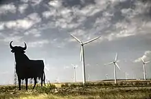 Image 15Wind turbines are typically installed in windy locations. In the image, wind power generators in Spain, near an Osborne bull. (from Wind power)