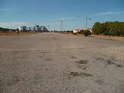 The site in 2010: the old airfield runway and housing buildings under construction in the northern part (Saint-Exupéry district)