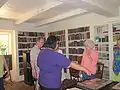 Tour guide points to a rare book in the plantation library