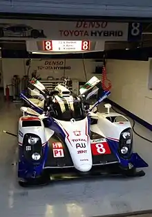 White-and-blue car in the pits