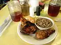 Twice cooked chicken, potato salad, purple hull peas, corn bread, and iced tea