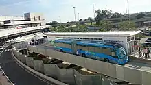 Blue articulated bus at an airport stop