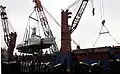 Adak being lifted on a transport ship, en route to the Persian Gulf.