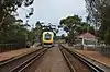 Passenger train stopped at small side platform