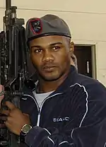 Puerto Rican boxer Félix Trinidad posing with an M-240 during a visit to the 720th Advanced Skills Training flight.