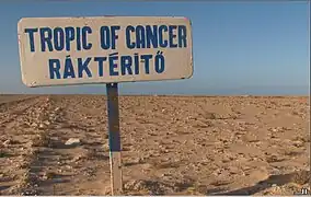 Road sign south of Dakhla, Western Sahara marking the Tropic of Cancer. The sign was placed by Budapest-Bamako rally participants; thus, the inscription is in English and Hungarian.