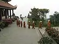 Monks of the Trúc Lâm school of Buddhism of Tây Thiên Zen Monastery are on their way to the cafeteri