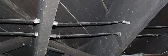 Ceramic tubes protecting wires passing through ceiling joists.