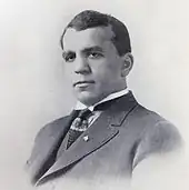 Grayscale portrait photo of Two-Gun Cohen in a suit