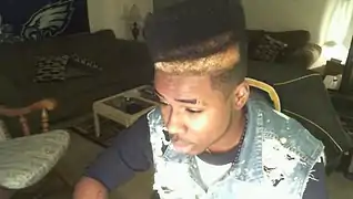 Image 44American teenager with hi-top fade and distressed acid wash denim vest (from 2010s in fashion)