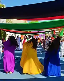 Image 20An Emirati folk dance, the women flip their hair sideways in brightly coloured traditional dress. (from Culture of the United Arab Emirates)