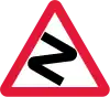 Series of bends ahead (1965–1975). This sign is rarely still used today (for sharp/dangerous bends)