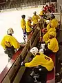 The Fighting Mondales bench during a game against Hamline University.