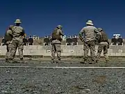 A USMC marksmanship instructor watching marksmen engage targets during the Combat Marksmanship Coaches Course at MCAS Miramar in 2015