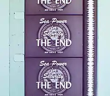 Vertical section of filmstrip, showing four-and-a-half frames, each of which reads, "Sea Power for Security. The End." Alongside the frames runs a continuous vertical white band of continuously fluctuating width.