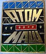 A metal badge (pin) with an "Atommash" sign (70-80-s)