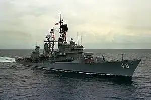 A grey painted ship on the ocean.