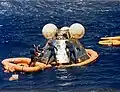 US Navy divers from USS New Orleans recovering the ASTP Apollo Command Module in July 1975.