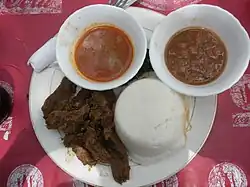 Image 7Ugali, served here with beef and sauce, is a mainstay of the cuisine throughout the African Great Lakes region. (from Culture of Kenya)