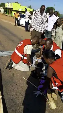 Uganda Red Cross Masaka Branch volunteers attending to a person