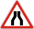 Road narrows on both sides