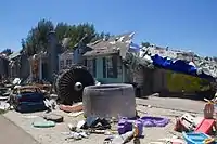 A set with a house mostly destroyed by a plane crash