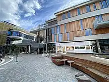 University campus buildings constructed of timber and concrete, outdoor staircases and new landscape and paving.