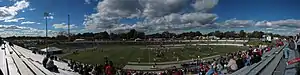 A panorama of a medium sized former college football stadium.