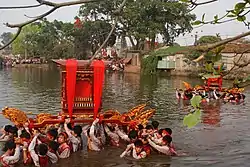 Procession of Saints through the village pond