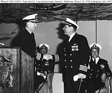 Capt. Kent Lee (left standing) taking command of the USS Enterprise