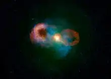 Teacup Galaxy SDSS 1430 +13 with images from Hubble (blue) and the Very Large Array (orange), showing both bubbles